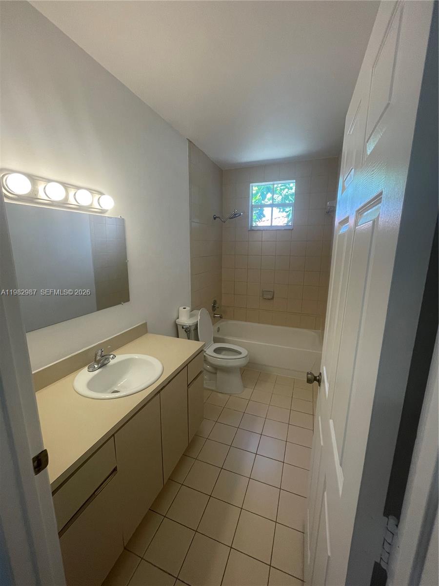 3421 Southwest 25th Street, Unit 1 Miami, FL 33133 - Photo 21 of 41 a bathroom with a granite countertop sink and a mirror