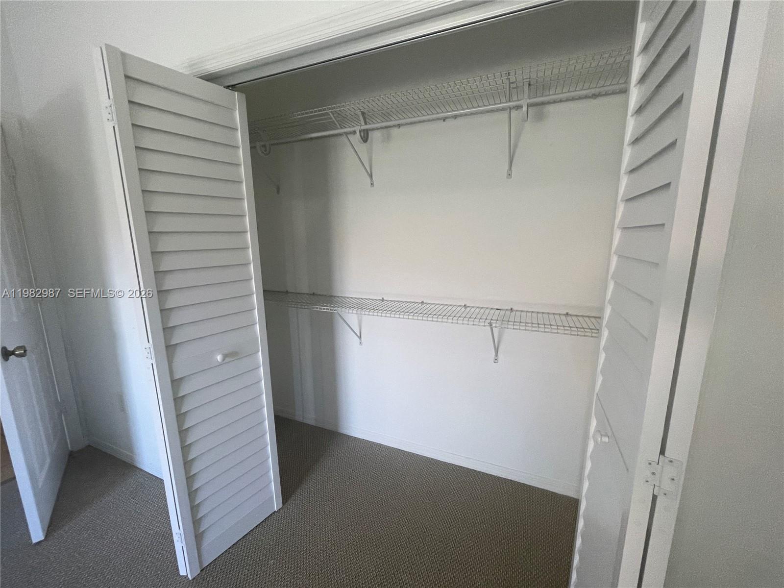 3421 Southwest 25th Street, Unit 1 Miami, FL 33133 - Photo 32 of 41 a view of walk in closet with empty racks