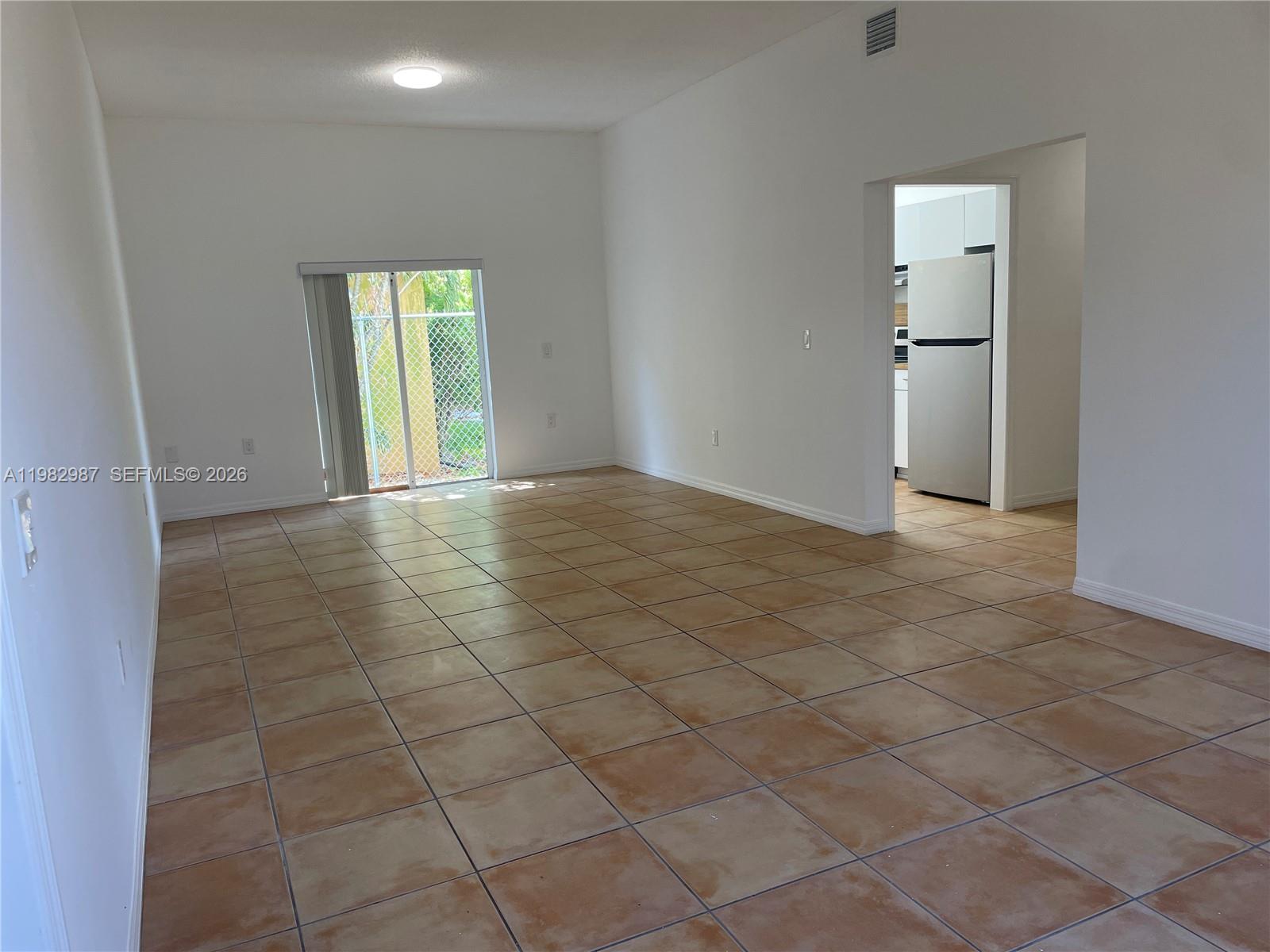 3421 Southwest 25th Street, Unit 1 Miami, FL 33133 - Photo 6 of 41 an empty room with kitchen and a window