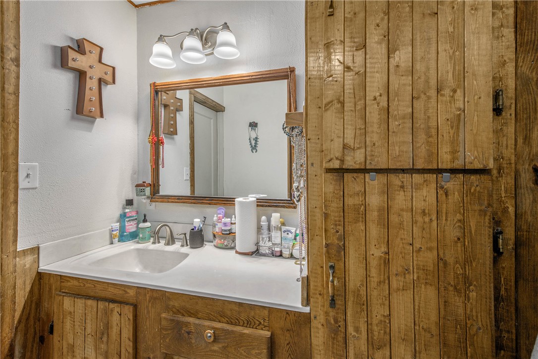 14452 Old Hearne Road Bryan, TX 77807 - Photo 12 of 17 a bathroom with a sink and a mirror