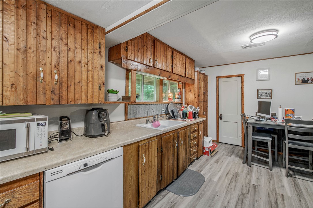 14452 Old Hearne Road Bryan, TX 77807 - Photo 7 of 17 a kitchen with sink stove and cabinets