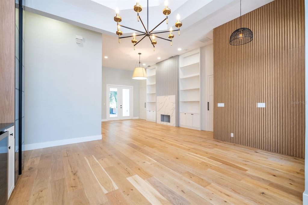 11213 Camden Park Drive Windermere, FL 34786 - Photo 12 of 99 a view of an empty room with wooden floor and a ceiling fan