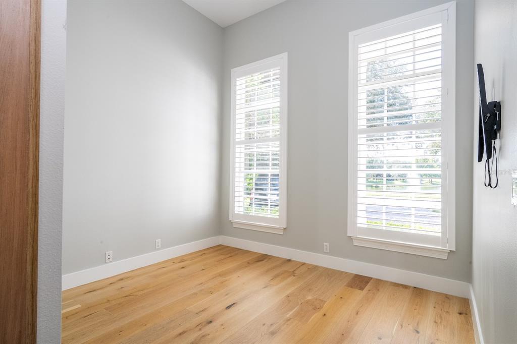 11213 Camden Park Drive Windermere, FL 34786 - Photo 16 of 99 a view of an empty room with wooden floor and a window