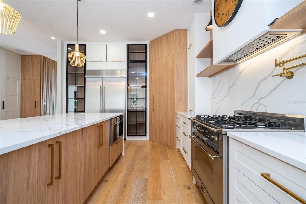 11213 Camden Park Drive Windermere, FL 34786 - Photo 32 of 99 a kitchen with stainless steel appliances granite countertop a stove and a refrigerator