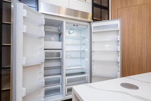 a view of walk in closet with empty racks