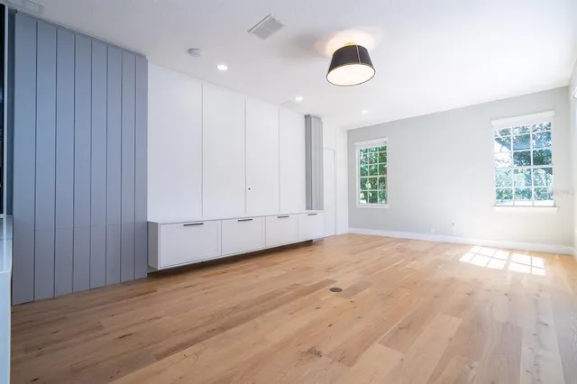 a view of empty room with wooden floor