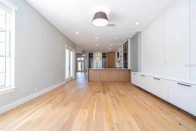 a view of a room with wooden floor and a window