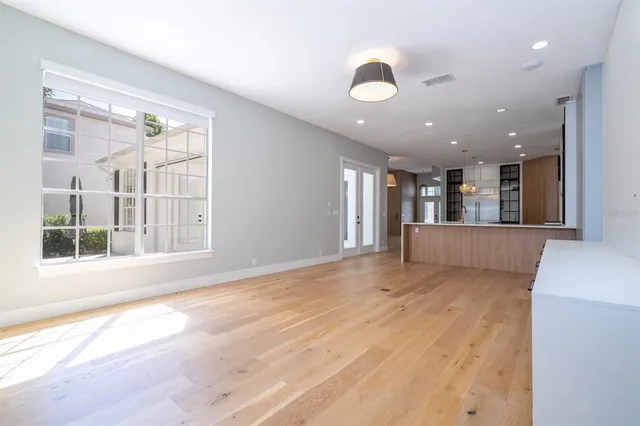 a view of empty room with wooden floor