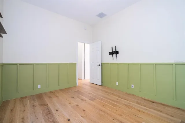a view of a big room with wooden floor and a ceiling fan