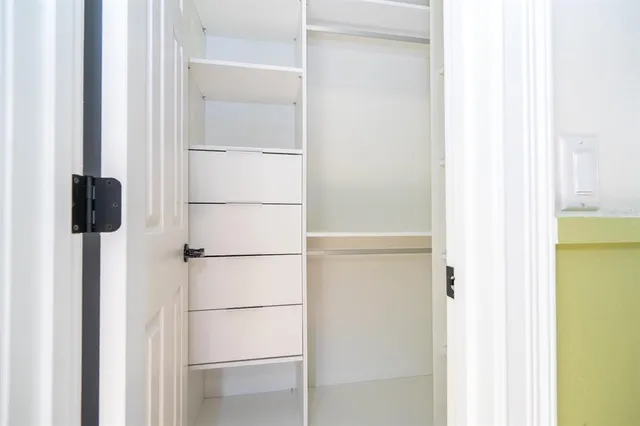 a view of storage and utility room with racks on the wall