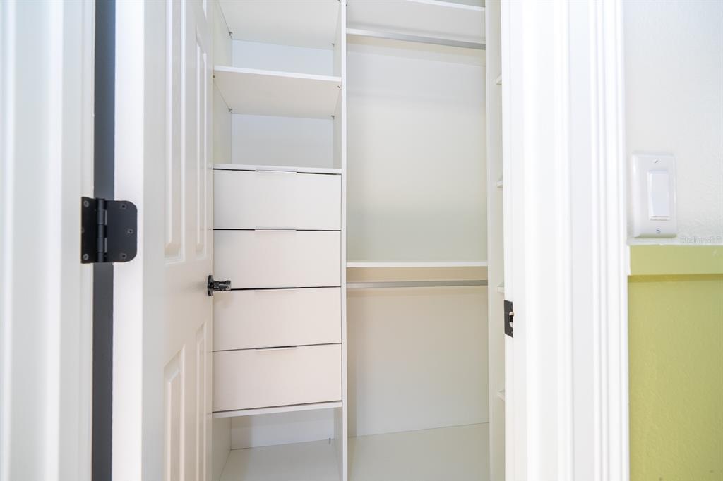 11213 Camden Park Drive Windermere, FL 34786 - Photo 50 of 99 a view of walk in closet with empty racks