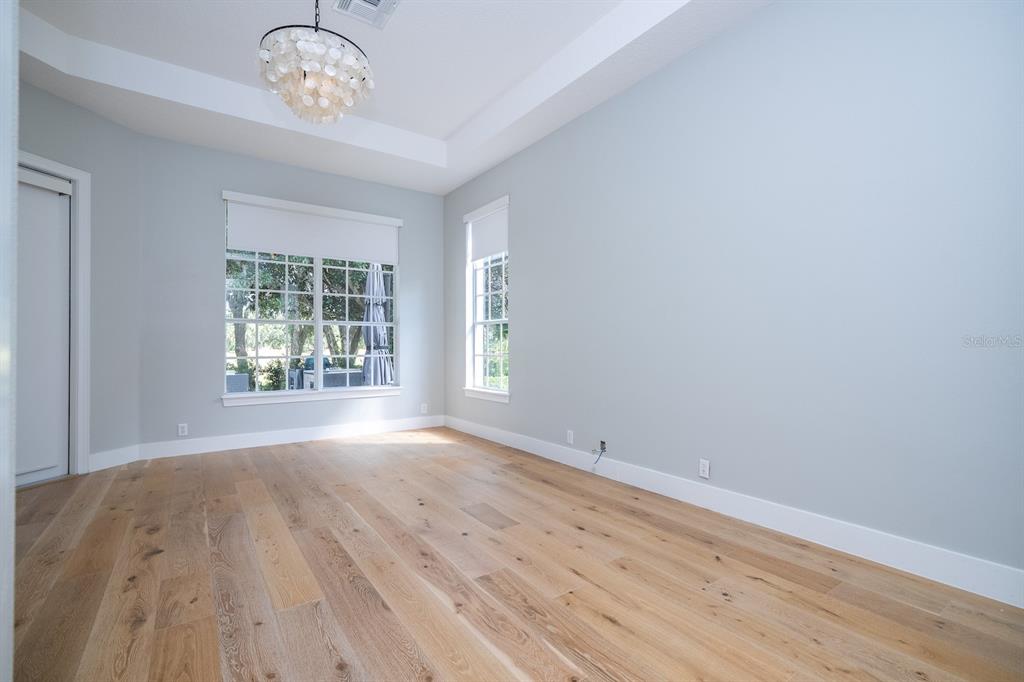 11213 Camden Park Drive Windermere, FL 34786 - Photo 60 of 99 an empty room with wooden floor and windows