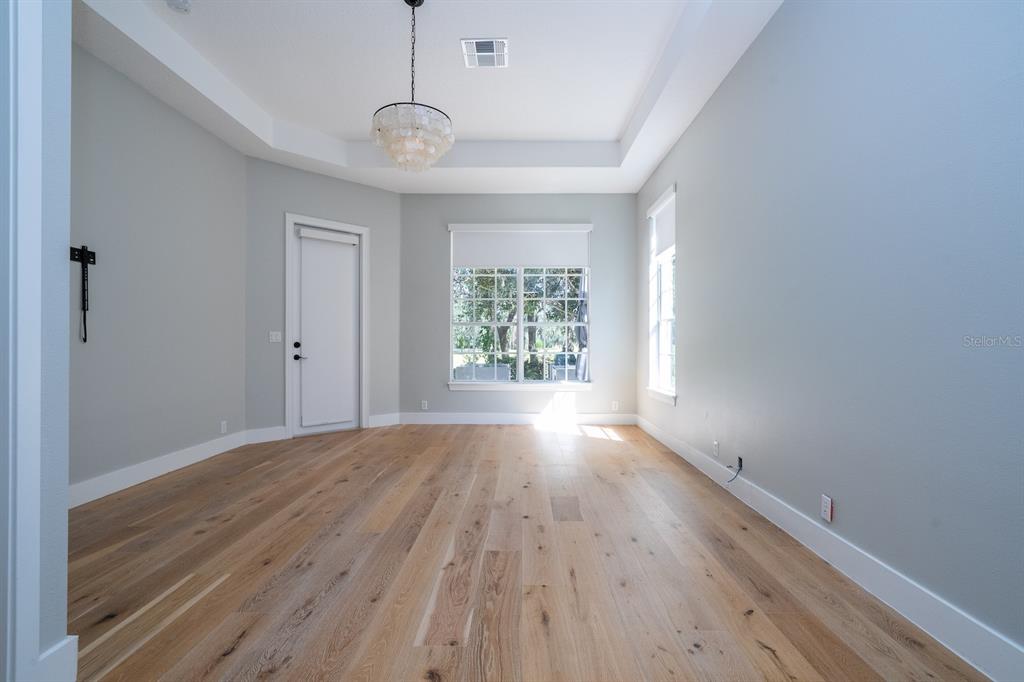11213 Camden Park Drive Windermere, FL 34786 - Photo 61 of 99 a view of an empty room with wooden floor and a window