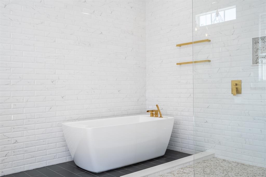 11213 Camden Park Drive Windermere, FL 34786 - Photo 68 of 99 a white tub sitting in a bathroom