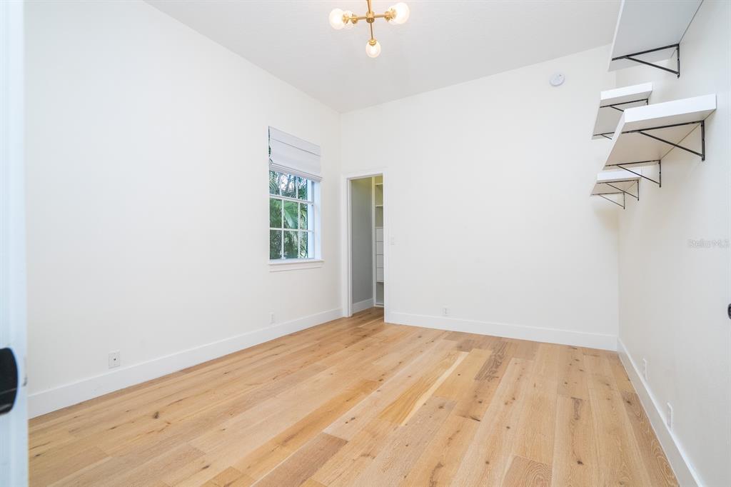 11213 Camden Park Drive Windermere, FL 34786 - Photo 88 of 99 a view of empty room with wooden floor and fan