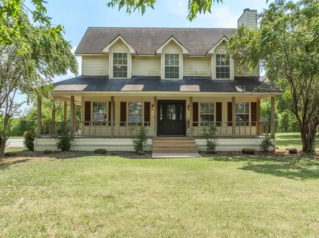 a view of a house with garden and sitting area