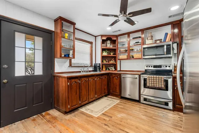 a kitchen with stainless steel appliances granite countertop a stove and a refrigerator