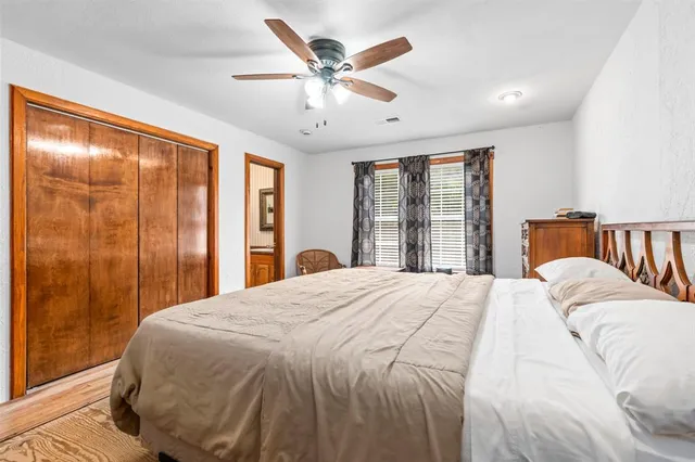 a bedroom with a large bed and a large window