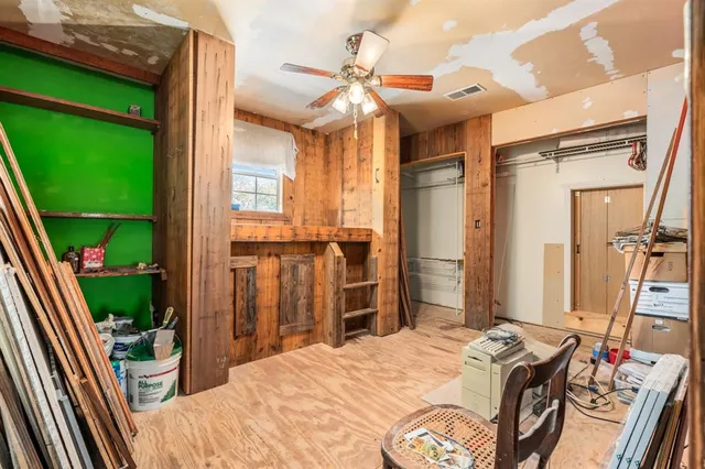 a bedroom with a bed dresser and a window