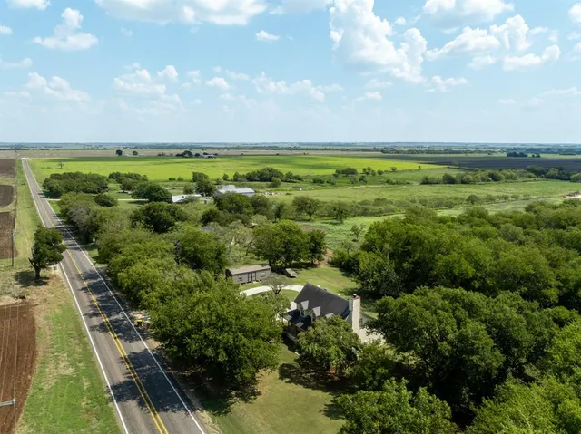 an aerial view of a house with a yard basket ball court and outdoor seating