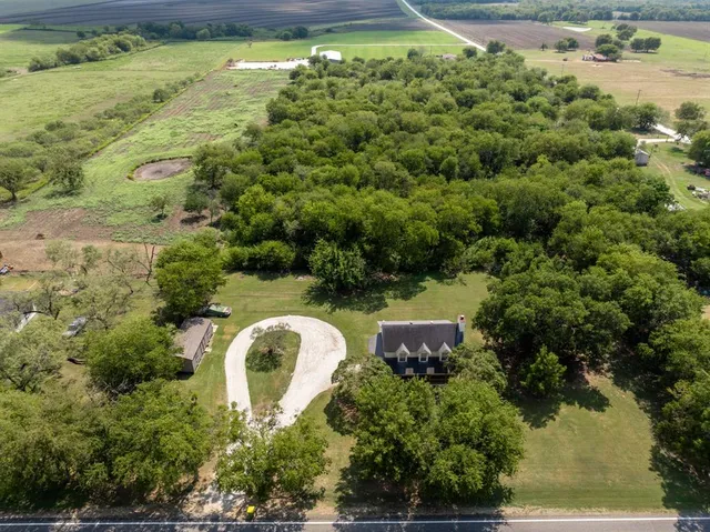 an aerial view of a house with outdoor space and lake view