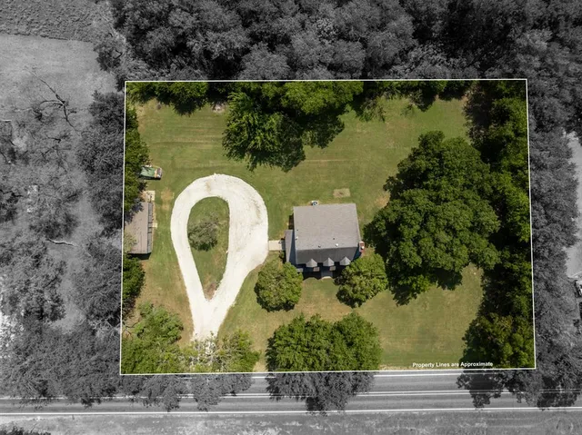 an aerial view of a house with outdoor space and lake view