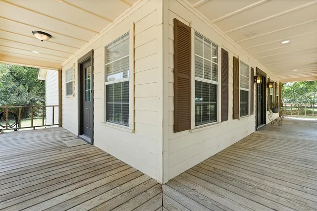 a view of a balcony with wooden floor