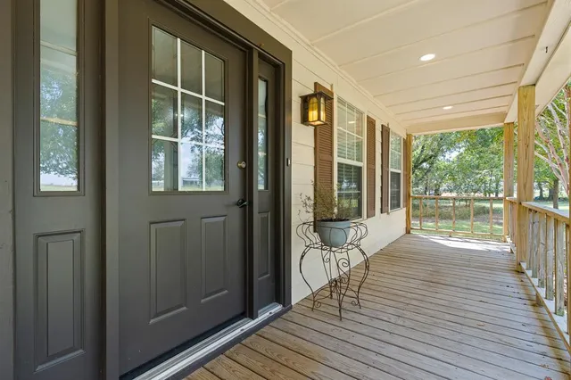 a view of outdoor space with wooden floor and windows