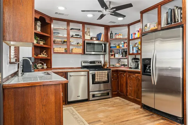 a kitchen with stainless steel appliances granite countertop a refrigerator and a sink