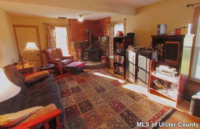 663 Wheat Hill Road Sidney Center, NY 13839 - Photo 3 of 4 a living room view with furniture and a floor to ceiling window