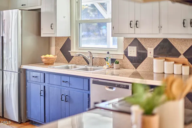 a kitchen with a sink a cabinets and window