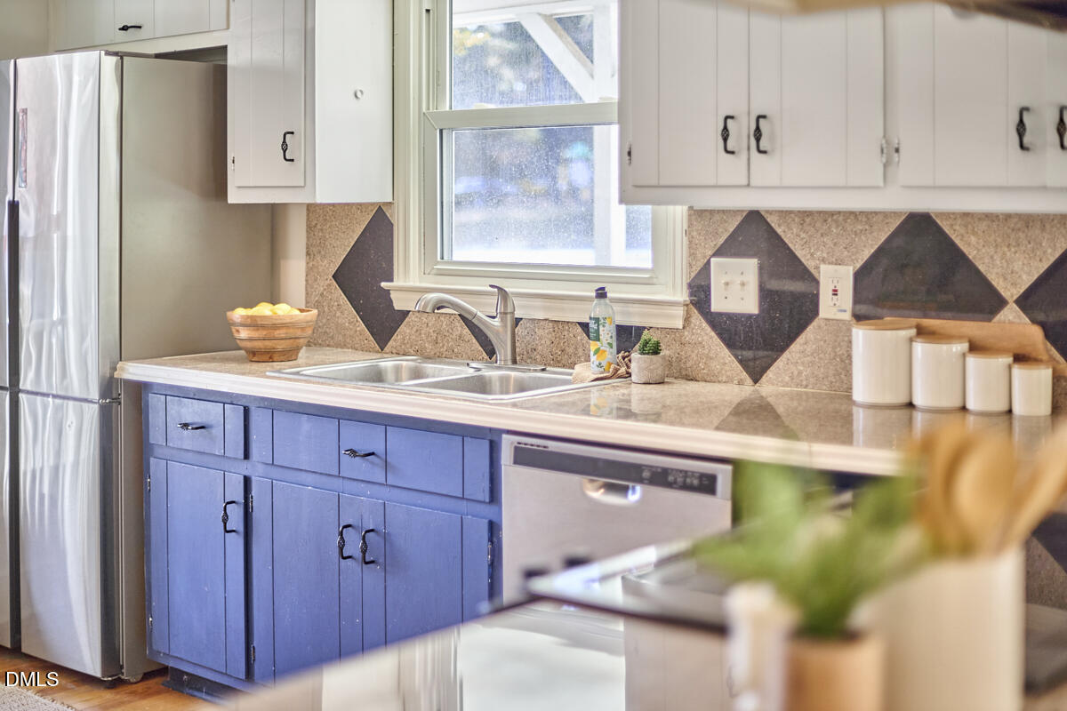 1918 Peppertree Street Durham, NC 27705 - Photo 14 of 45 a kitchen with a sink a cabinets and window