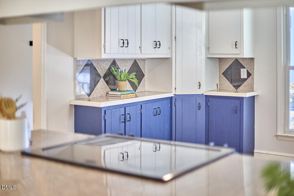 1918 Peppertree Street Durham, NC 27705 - Photo 17 of 45 a kitchen with cabinets a sink and a stove