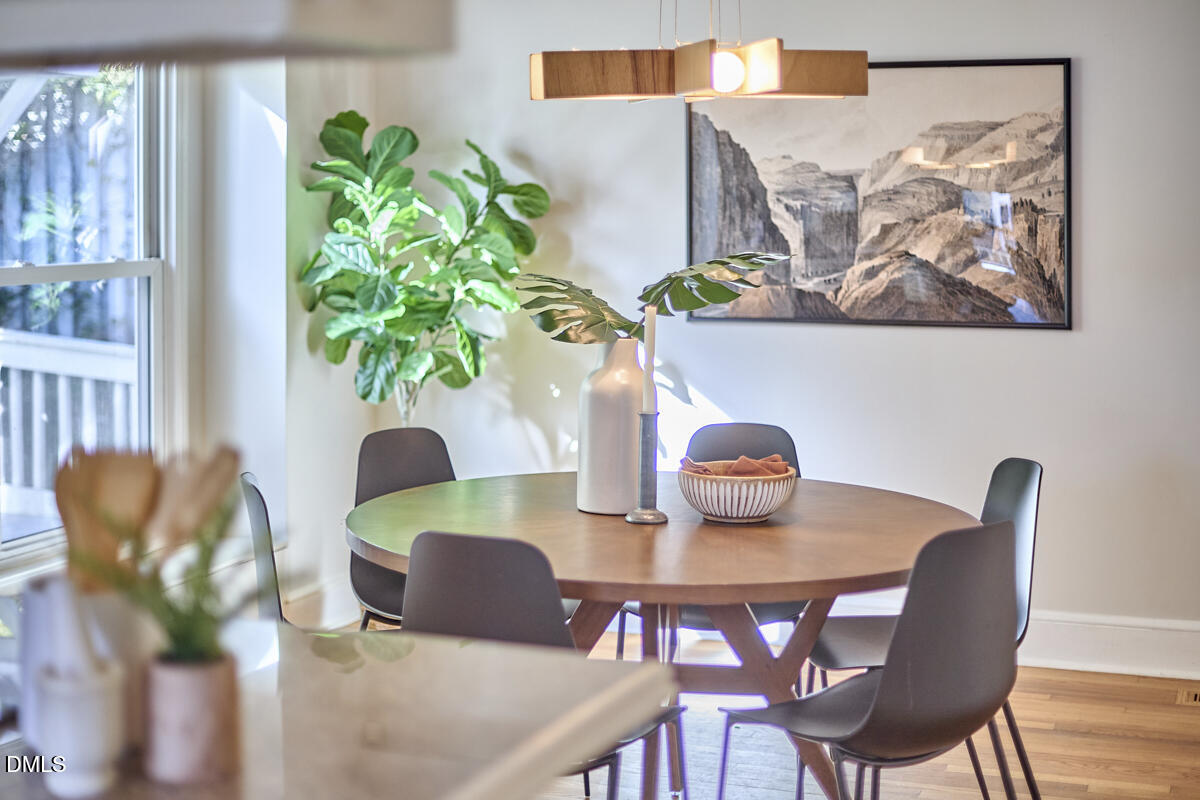 1918 Peppertree Street Durham, NC 27705 - Photo 22 of 45 a view of a dining room with furniture a potted plant and wooden floor