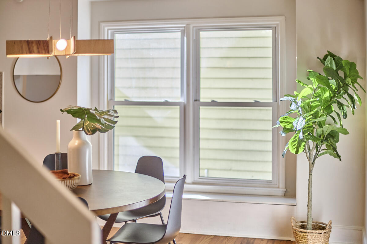 1918 Peppertree Street Durham, NC 27705 - Photo 23 of 45 a vase of flowers sitting next to a window