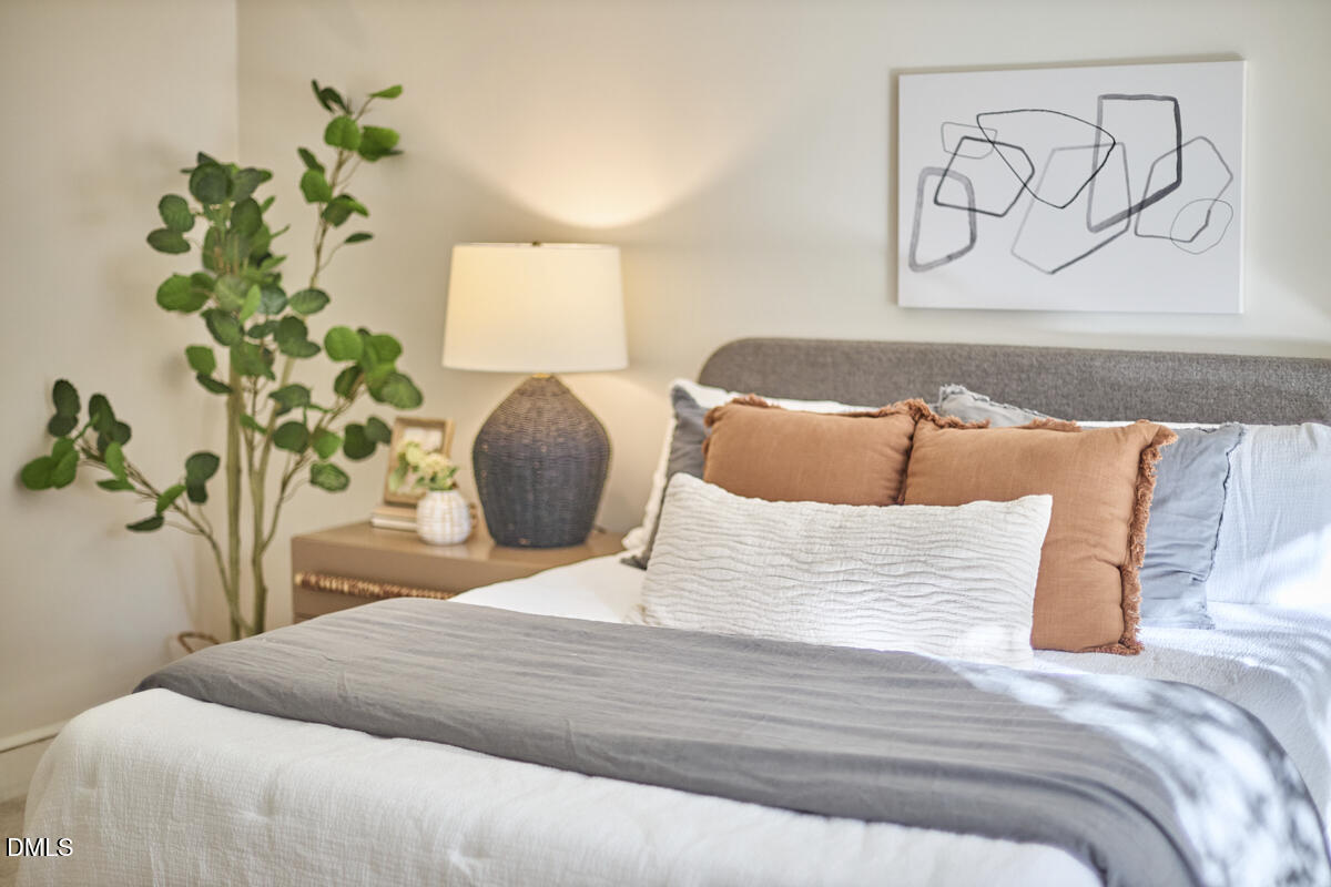 1918 Peppertree Street Durham, NC 27705 - Photo 27 of 45 a bedroom with a bed and a potted plant