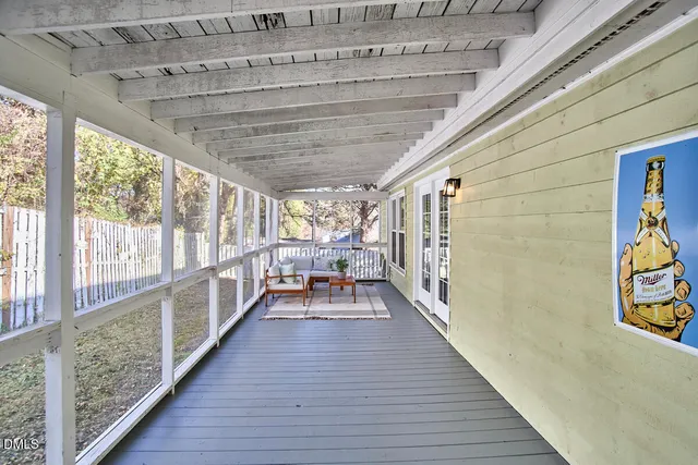 a hallway with wooden floor and furniture