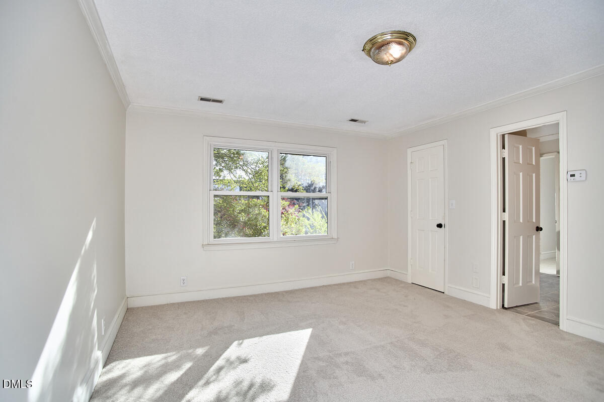 1918 Peppertree Street Durham, NC 27705 - Photo 32 of 45 a view of an empty room with a window