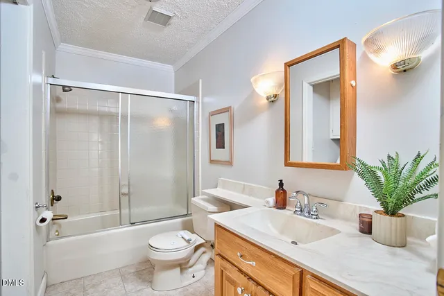 a bathroom with a granite countertop sink a toilet a mirror and shower