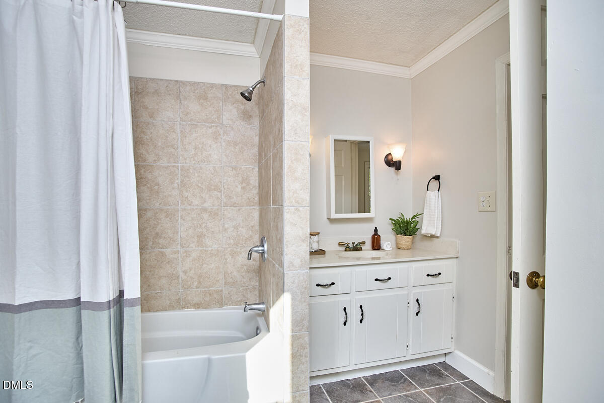 1918 Peppertree Street Durham, NC 27705 - Photo 36 of 45 a bathroom with a double vanity sink mirror and shower