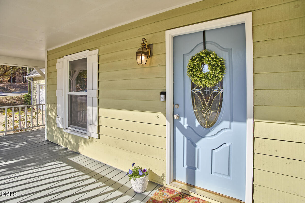 1918 Peppertree Street Durham, NC 27705 - Photo 40 of 45 a front view of a house with a potted plant and a window