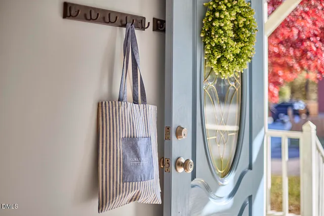 a view of a hallway with wooden floor and a mirror