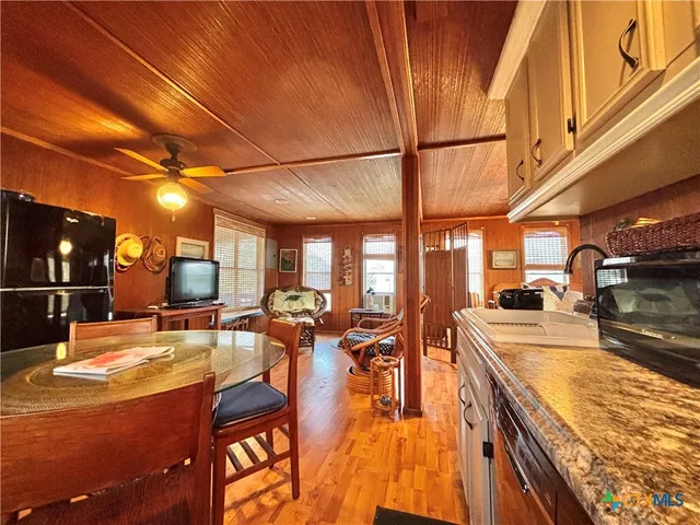 a view of a kitchen with lots of counter top space and living room