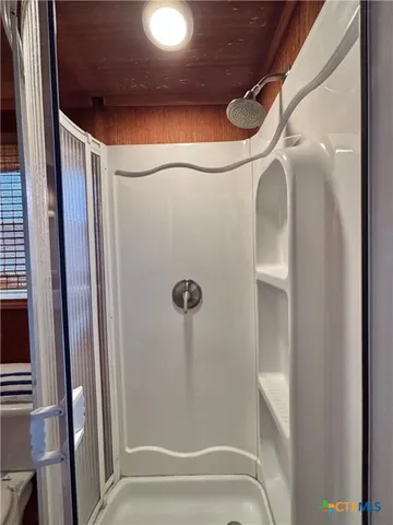 a dining room with furniture and a floor to ceiling window