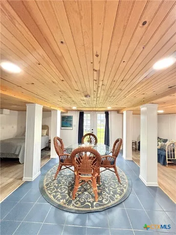 a dining room with furniture and glass door