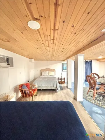 a bedroom with furniture and natural light