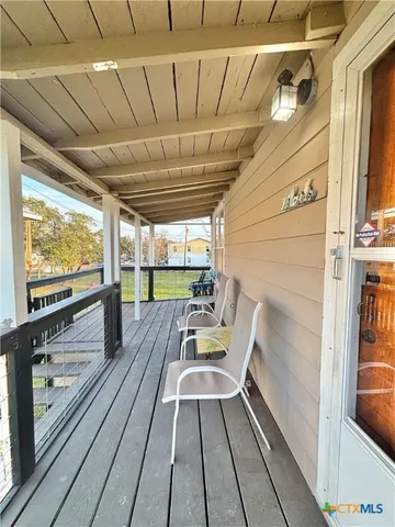 a view of a balcony with wooden floor