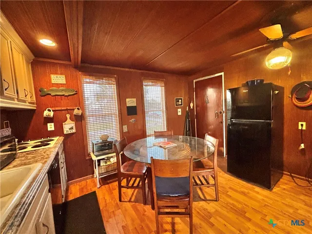 a kitchen with stainless steel appliances kitchen island granite countertop a refrigerator and microwave