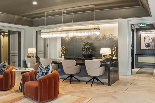 a dining room with furniture a chandelier and a flat screen tv