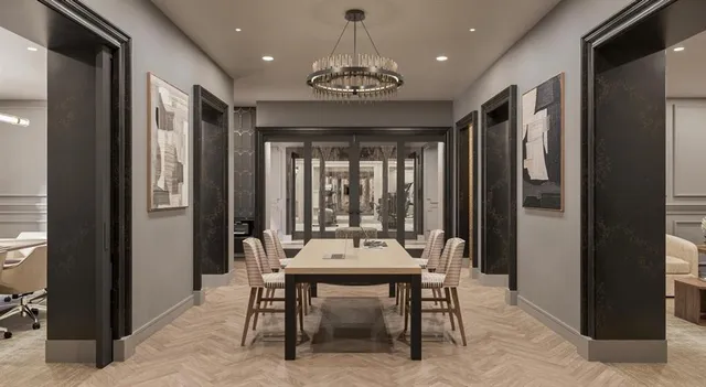 a kitchen with stainless steel appliances kitchen island granite countertop a dining table chairs and white cabinets